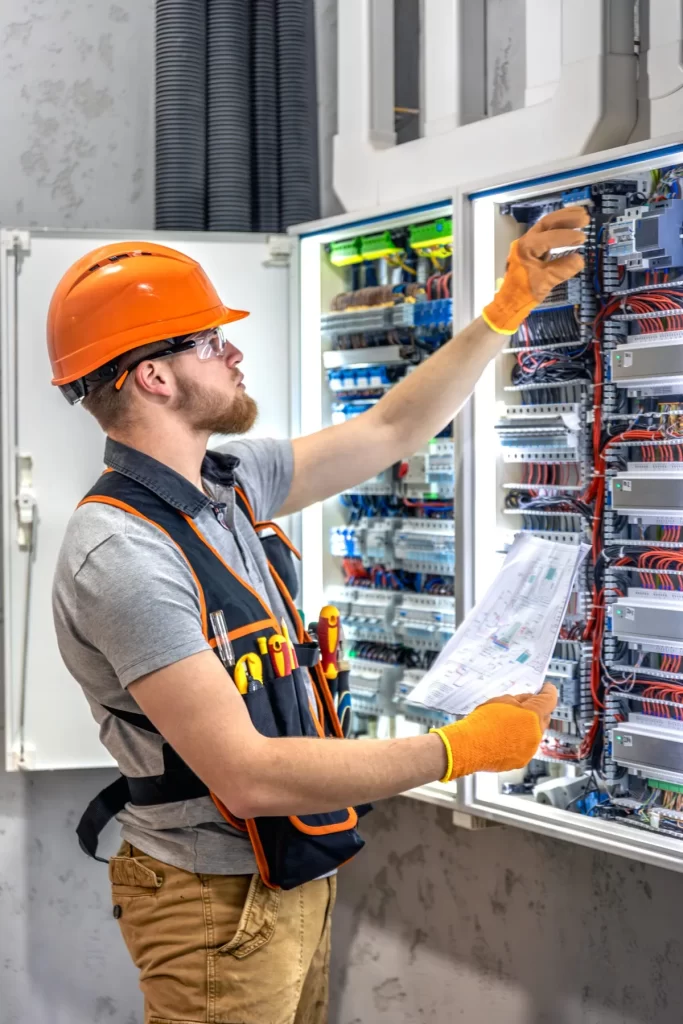 Green Energy Victoria electrician working on an electrical panel